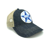 A Blue denim bill and front with a clay colored mesh back. Adjustable velcro strap on the back. A large rustic patch of the Blue Star Highway logo on the front.